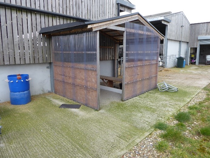 A dedicated shed set against the main calf shed for changing boots and overalls